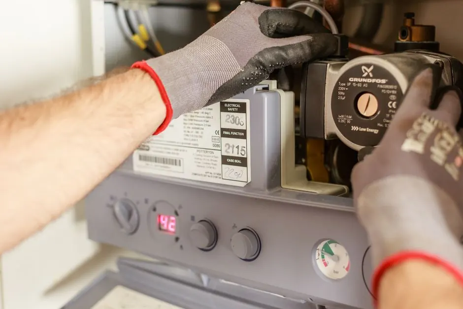 Technician performing pressure test on gas piping with gauges in Apex NC