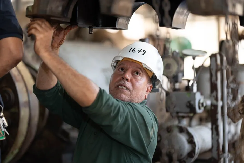 Technician examining commercial gas equipment in a Apex NC business facility
